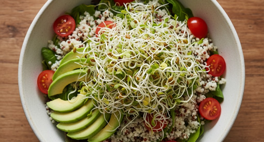 A healthy grain bowl topped with fresh sprouted seeds.